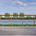 Brown Railing Along River With Green Grass Gray Pavement Trees Under Blue Sky White Clouds