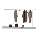 Stylish Clothes Hanging On Rack With Brown Bags And High Heels