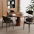 Modern Dining Area With Round Wooden Table Black Chairs And Green Plants