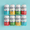 Atlanta Brewing Co Canned Drinks In Assorted Colors Arranged On Light Blue Background