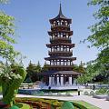 Scenic Circular Plaza Landscape With Pagoda Tower Greenery Trees Flower Beds Walkways And Seats
