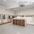 Modern Clothing Store Interior Featuring Clothing Racks Displayed Apparel And Checkout Counter