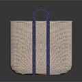 Stylish Brown Woven Handbag With Blue Handles And Minimalist Design