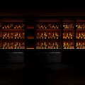Illuminated Modern Wine Cabinet Lined With Various Wine Bottles In Dark Room