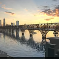 Steel Truss Bridge Carries Cars And High Speed Train At Golden Sunset Over Calm River