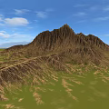 Scenic Mountain Landscape With Brown Textured Peak Green Grassy Fields And Blue Sky White Clouds