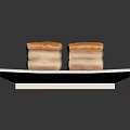 Layered Square Pastries with Golden Crust and Red White Layers on White Square Plate