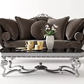 Elegant Brown Sofa with Pillows and Black Coffee Table Set with Silver Legs and Vase