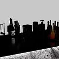 Stylish Wine Bottles And Glasses On Black Countertop With Bar Tools Ice Bucket And Trays