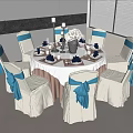 Round Dining Table With Beige Chairs Blue Bows White Tablecloth Tableware Vase And Candle Holders