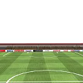 Football Stadium Featuring Green Turf Red Seating Stands White Marking Lines And Floodlight Poles