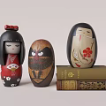 Three Traditional Decorative Dolls With Colorful Designs On Stacked Books
