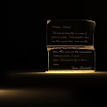 Crystal Table Lamp With Engraved Text And Unique Curved Design Illuminated In Dark Room