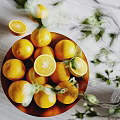Fresh Ripe Oranges In A Bowl With Whole And Sliced Pieces And Green Leaves