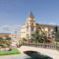 Scenic Landscape With Stone Bridge Water Pool Green Lawns And Historic Buildings Under Blue Sky