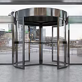 Modern Building Entrance With Glass Revolving Door And Potted Green Plants