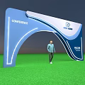 Blue White Arched Conference Entrance With Welcome Text Logo And Green Grass