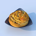 Delicious Spiral Bread with Golden Crust on Dark Square Plate Topped with Nuts
