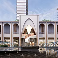 Modern Building Exterior With Curved Arches Water Feature Sculpture In Open Plaza High Rise Background