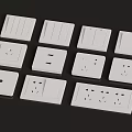 Assorted White Electrical Switches And Wall Sockets With Different Designs