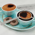 Two Cups Of Coffee On Blue Plate With Star Shaped Cookies And Metal Strainer