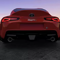 Sleek Red Sports Car Parked On Concrete Ground During Sunset Sky
