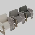 Beige Single Sofa with Wooden Armrests and Legs Topped with Black and White Herringbone Blanket