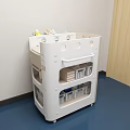White Medical Cart With Storage Shelves Holding Medical Supplies In Hospital Room