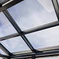 Outdoor Modern Glass Roof Sunroom With Black Frame And Grass Surroundings