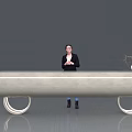 Modern Reception Desk With Receptionist Standing Behind Green Plant And Decorative Vase On Sleek Surface