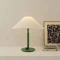 Modern Green Table Lamp With White Fabric Lampshade On Desk By Books And Artwork