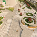Urban Plaza With Palm Trees Stone Pavement Green Landscaping And Pedestrians