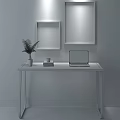 Modern Glass Top Desk With Green Plant Vase Laptop Books and Framed Botanical Prints
