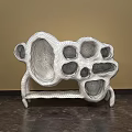White Abstract Sculpture Carving with Hollow Holes and Textured Surface in Indoor Setting