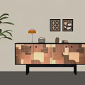 Modern Wooden Patchwork Console Cabinet With Orange Table Lamp Decorative Paintings And Green Plant