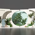 Floral Art Installation For Fashion Clothing Display Area With Circular Window And Fresh Green Plants