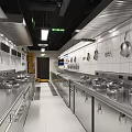 Commercial Kitchen Interior With Stainless Steel Shelves Green Decoration Spice Jars And Menu Board