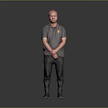 Man Standing in Gray Polo Shirt with Yellow Logo and Hands Crossed on Gray Background