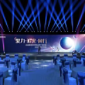 Elegant Event Stage Setup With Blue Laser Lighting And Round Tables Arrangement
