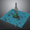 Green Glass Bottle With Silver Top On Blue Square Mat With Brown Spots