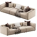 Cozy Modern Beige Three Seater Sofa With Brown White Pillows And Throw Blanket