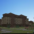 Multistory Residential Building With Red Brick Beige Exterior Green Lawn Flowers And Trees