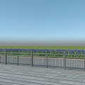 Metal Fence With Blue Flowers Along Wooden Deck And Green Grass Background
