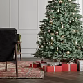 Festively Decorated Christmas Tree With Gifts Candles And Snowy Window View