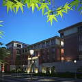 Red Brick School Building With Arched Doors Green Trees And Street Lamps Under Blue Sky