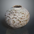 Intricate Spherical Sculpture Carving With Hollow White Patterns And Detailed Design