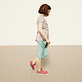 Woman In Short Sleeve Top Light Green Capri Pants With Red Shoes And Small Bag