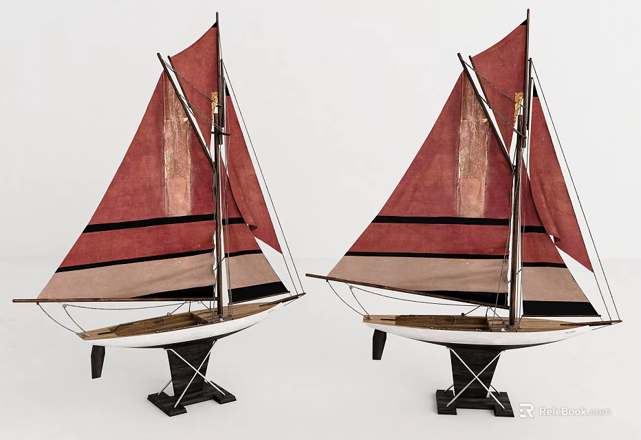 Two Decorative Sailboat Models With Red And Beige Sails Featuring Black Stripes On Black Bases 3d model 