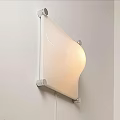 Modern Wall Light With Curved Frosted Glass Shade And Metal Frame Mounted On White Wall