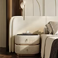Modern Cream Colored Bedside Table with Drawers Books and Cup Next to Bed with Pillows